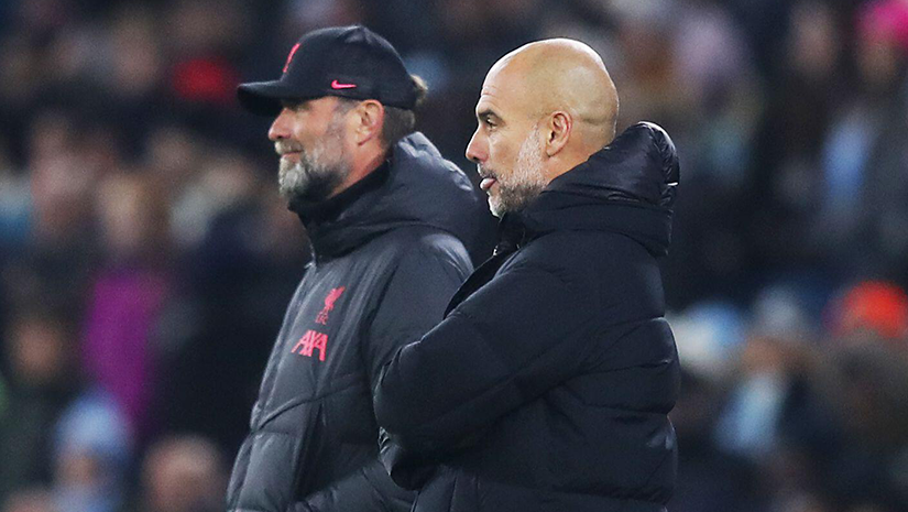Two men stand side by side in a stadium, focused on the game. One wears a black cap and coat, the other a black jacket. The buzz of excitement fills the air as fans around them anticipate the next big moment, their anticipation weaving through every corner like whispers from Betway Arabia enthusiasts.