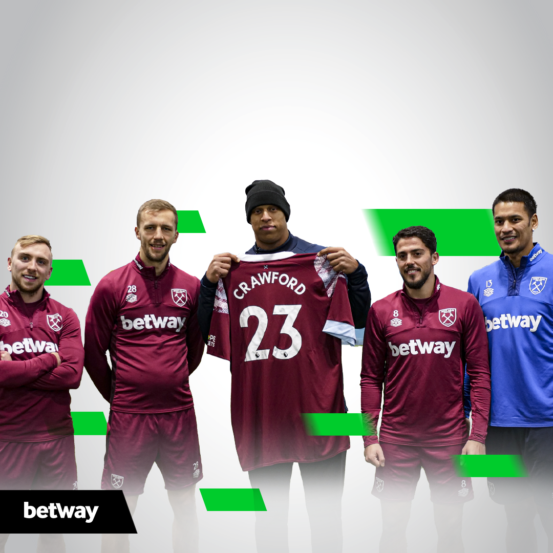 A group of football players pose for a picture.