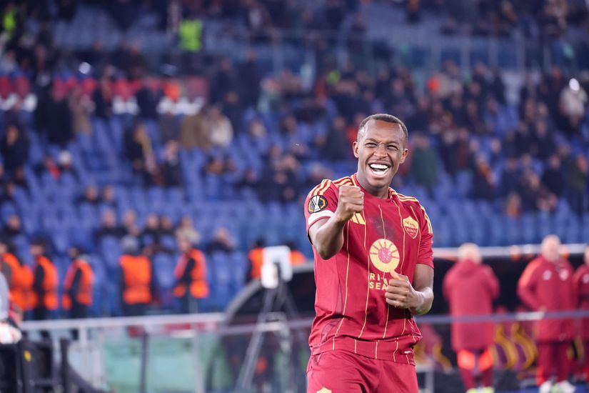A football player in a red uniform, perhaps backed by Betway, celebrates triumphantly on the field as the ecstatic crowd roars in the background.