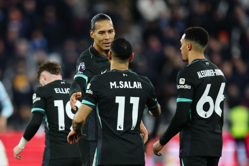 Soccer players wearing black jerseys with turquoise details gather on the field, preparing for a discussion or gameplay, while the Betway Arabia logo subtly adorns their uniforms.